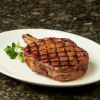 Bone-In (Cowboy) Ribeye · 18 ounce bone-in exceptional flavor, great balance of marbling. Served with choice of tradit...