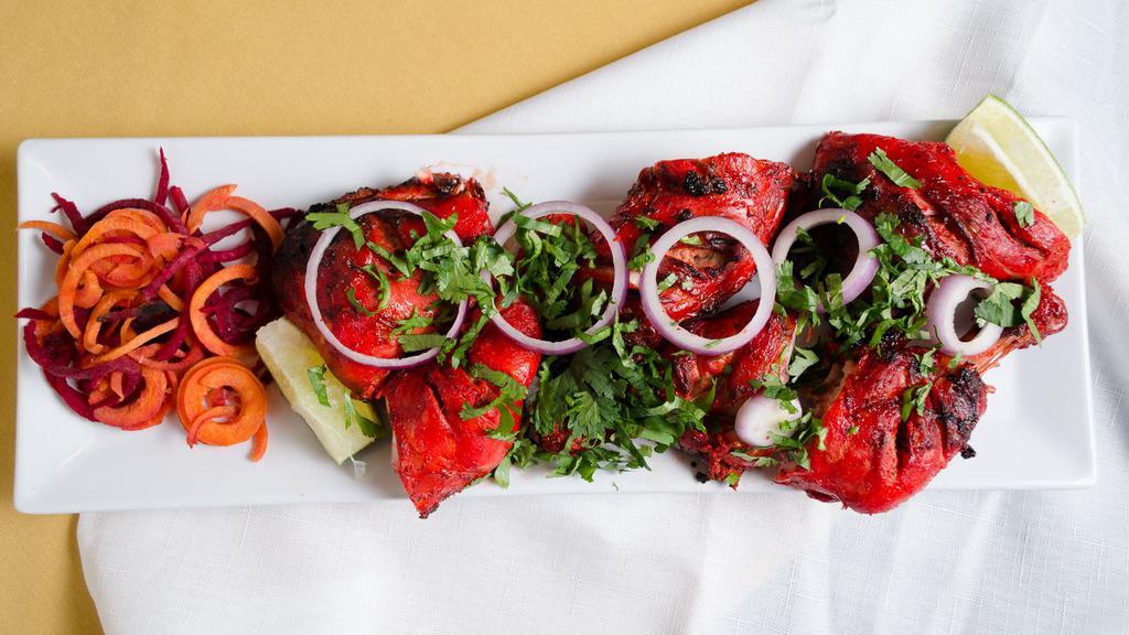 Tandoori Chicken · Chicken leg quarters in the chef's blend of herbs and spices broiled in the clay tandoor oven.