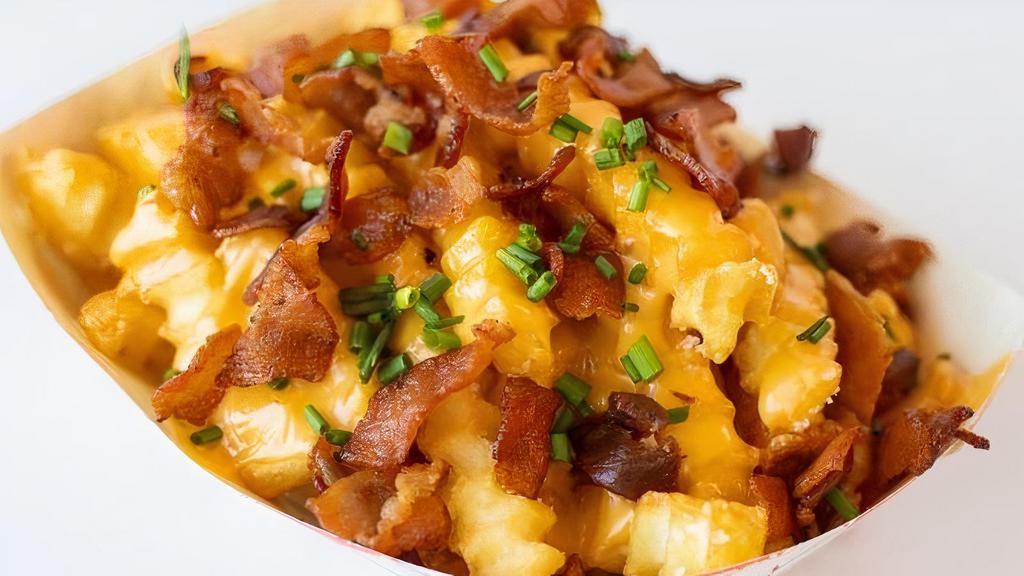Bacon Cheese Fries · Crinkle Cut Fries with Queso and Crumbled Crispy Bacon.