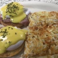 Classic Eggs Benedict · Two perfectly poached eggs and ham layered on a split, toasted English muffin, topped with r...