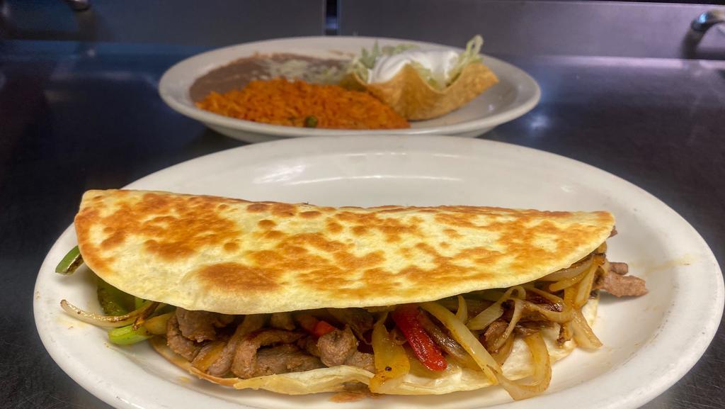 Quesadilla Fajita Dinner · Steak or chicken, grilled with onions bell peppers and tomatoes. Served with rice, beans, tossed salad and sour cream.