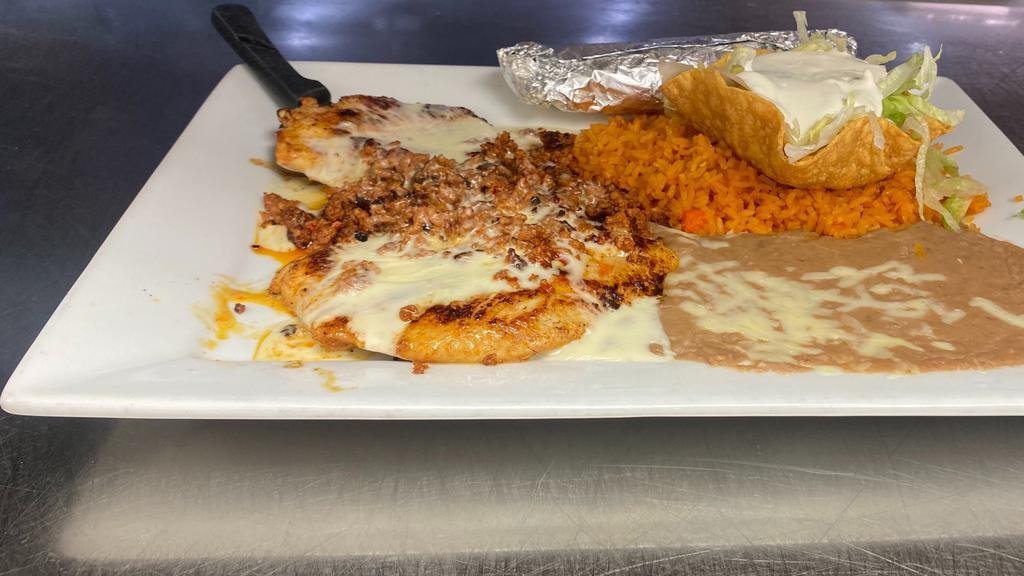 Chori-Pollo · Chicken breast covered with chorizo and cheese sauce. Served with rice, beans, lettuce and sour cream.