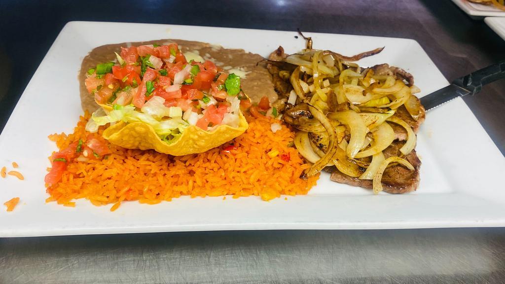 Carne Asada · Tender thin slices of rib-eye steak, served with rice, beans, pico de Gallo and tortillas