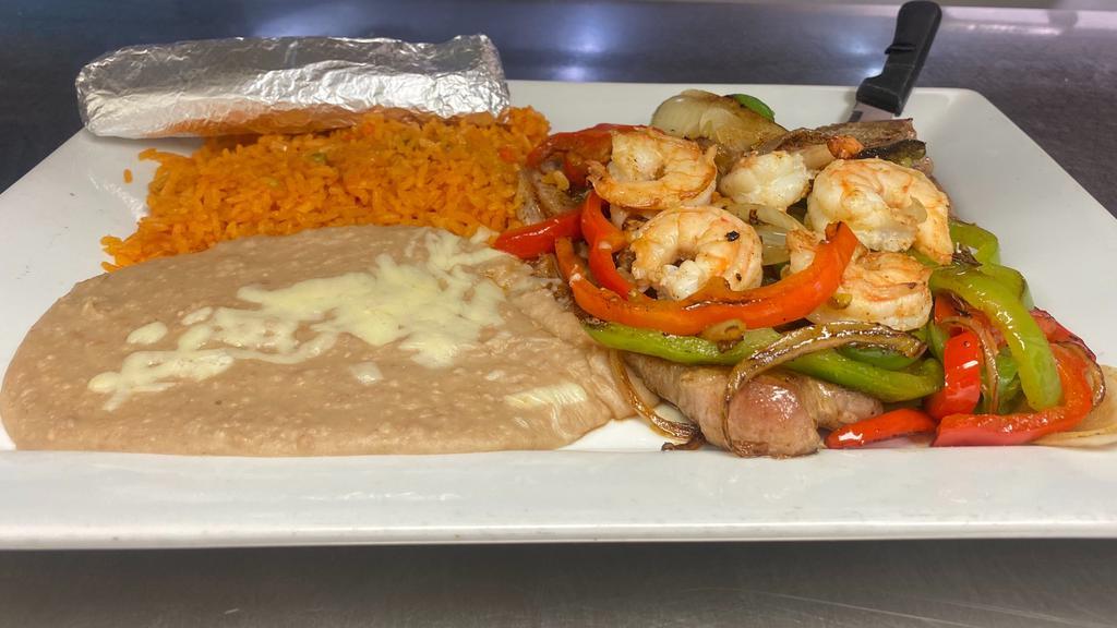 Steak Veracruz · T-bone steak and shrimp, topped with grilled onions, bell peppers, tomatoes. Served with rice and beans and tortillas.