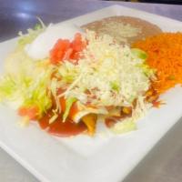 Enchiladas Mexicanas · Two flour tortillas filled with grilled chicken or steak. Served with rice and beans, lettuc...