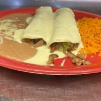 Flacos Burritos · Two steak and cheese burritos with lettuce, served with rice and beans.