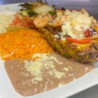 Piña Fajita · Steak, chicken and shrimp cooked with pineapple, bell peppers and onions, topped with cheese...