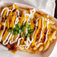 Kimchi Fries · Topped with kimchi, spicy pork, cheese, sour cream, and spicy mayo.