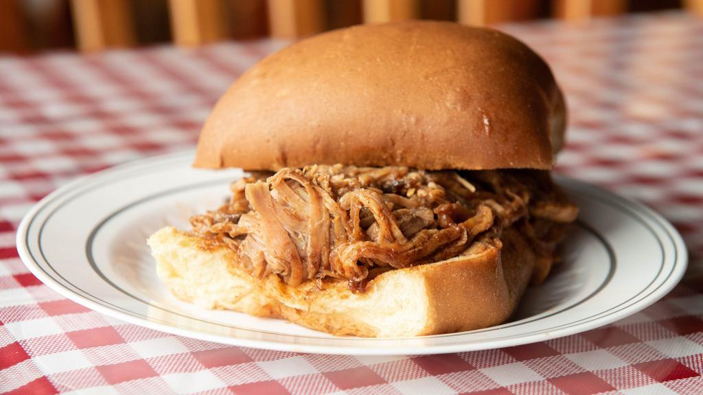 Smoked Pulled Pork Sandwich · Slow smoked, hand pulled apart and topped in our famous BBQ sauce.