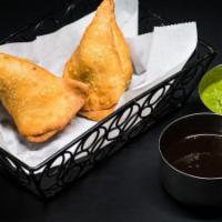 Veggie Samosa · Most famous triangular pastry filled with mashed potatoes and peas. Serves two. Limit two pe...