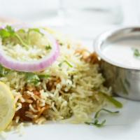 Chicken Biryani · Basmati rice and chicken cooked in aromatic spices; served with raita.