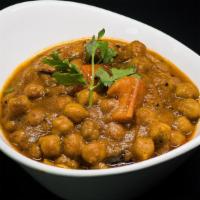 Chana Masala · Chickpeas slow cooked in thick masala gravy with cumin, ground turmeric and fresh coriander.