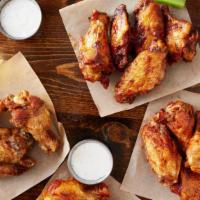 Crispy Wings · Four points favorite. Wet rubbed chicken wings tossed in your choice of sauce. Buffalo, garl...
