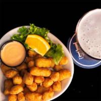 Wisconsin White Cheddar Cheese Curds · Fresh Wisconsin cheese curds beer battered with spotted cow. Served with a side of chipotle ...