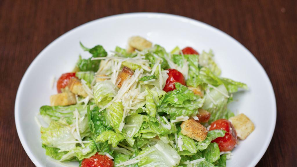 Caesar Salad · Torn romaine lettuce, Parmesan cheese, and croutons.