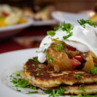 Deruny · Ukrainian style potato pancakes, caramelized onion relish topped with sour cream and fresh h...