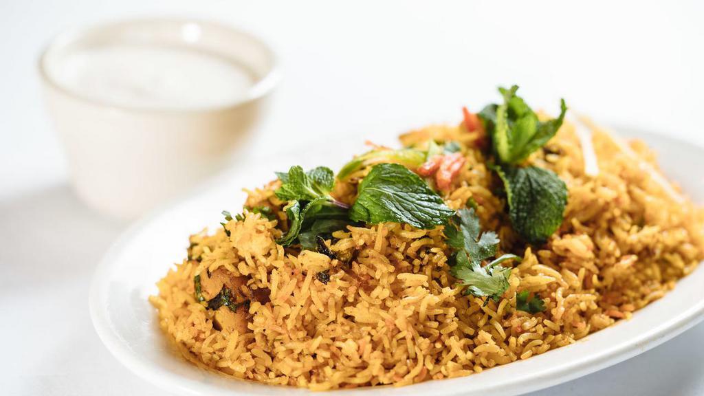Veg Biryani · Long grain basmati rice cooked with vegetables and homemade spices. Served with raita.