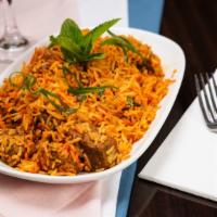 Goat Biryani · Long grain basmati rice cooked with flavored goat meat, and homemade spices, served with rai...