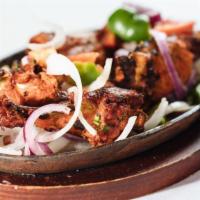 Tandoori Chicken · Five piece seasoned grilled chicken drumsticks with aromatic spices.