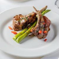 Chuletas De Cordero · Grilled lamb chops served with roasted potatoes, grilled asparagus, with a red wine sauce