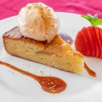 Tarta De Pera · Almond and pear pound cake, drizzled with caramel sauce, served with vanilla ice cream