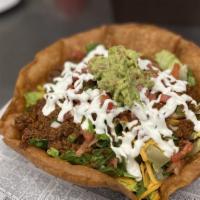Taco Bowl · Crispy tortilla shell filled with romaine lettuce, seasoned ground beef, shredded cheddar ch...