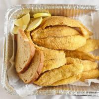 Catfish Fillet Dinner · Four pieces. Includes fries, coleslaw, dinner roll, and lemon wedge.