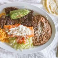 Carne A La Tampiquena · Skirt steak served with a cheese filled enchilada.