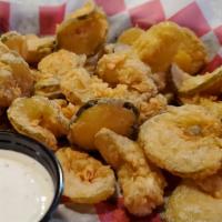 Fried Pickles · Dill pickle chips battered, breaded and fried to perfection.  Served with a side of ranch.