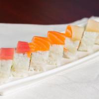 Rainbow Roll · Uncooked roll. Crab stick and cucumber inside with tuna, salmon, yellowtail, and avocado on ...