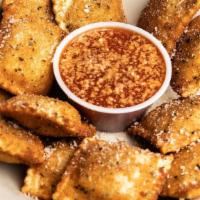 Toasted Ravioli · Golden brown beef ravioli breaded and sprinkled with Parmesan cheese. Served with marinara s...