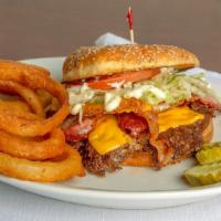 Royale Burger · A 1/3 lb all-natural burger topped with lettuce, tomato, mayonnaise, crisp bacon, American c...