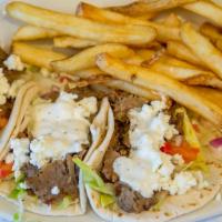 Gyro Tacos · 3 gyro tacos filled with gyro meat, feta cheese, shredded lettuce, tomatoes, red onion and a...
