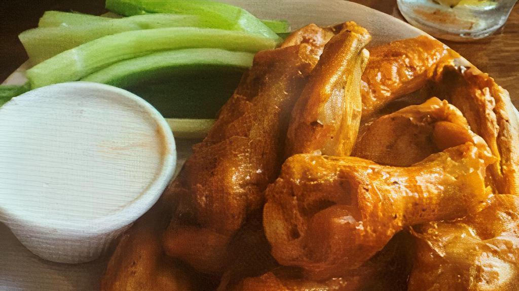 Baked Chicken Wings · Chicken wings baked until crispy, tossed in home-made buffalo or BBQ sauce and served with celery and bleu cheese.