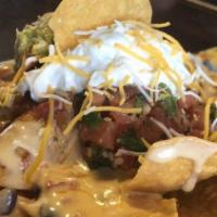 Tavern Nachos With Vegetarian · Tortilla chips topped with veggie chili jalapeno, sour cream and house-made queso, guacamole...
