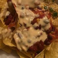 Tavern Nachos With Pulled Pork & Black Beans · Tortilla chips topped with jalapeno, sour cream and house-made queso, guacamole and pico de ...