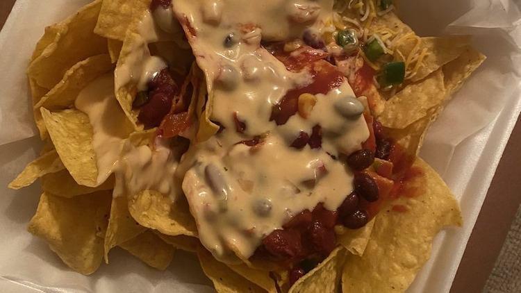 Tavern Nachos With Pulled Pork & Black Beans · Tortilla chips topped with jalapeno, sour cream and house-made queso, guacamole and pico de gallo.