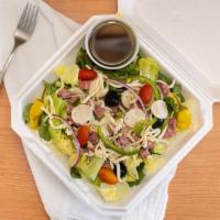 Italian Salad · Mixed greens, tomato, red onion, green pepper, black olives, hearts of palm, pepperoncini, m...