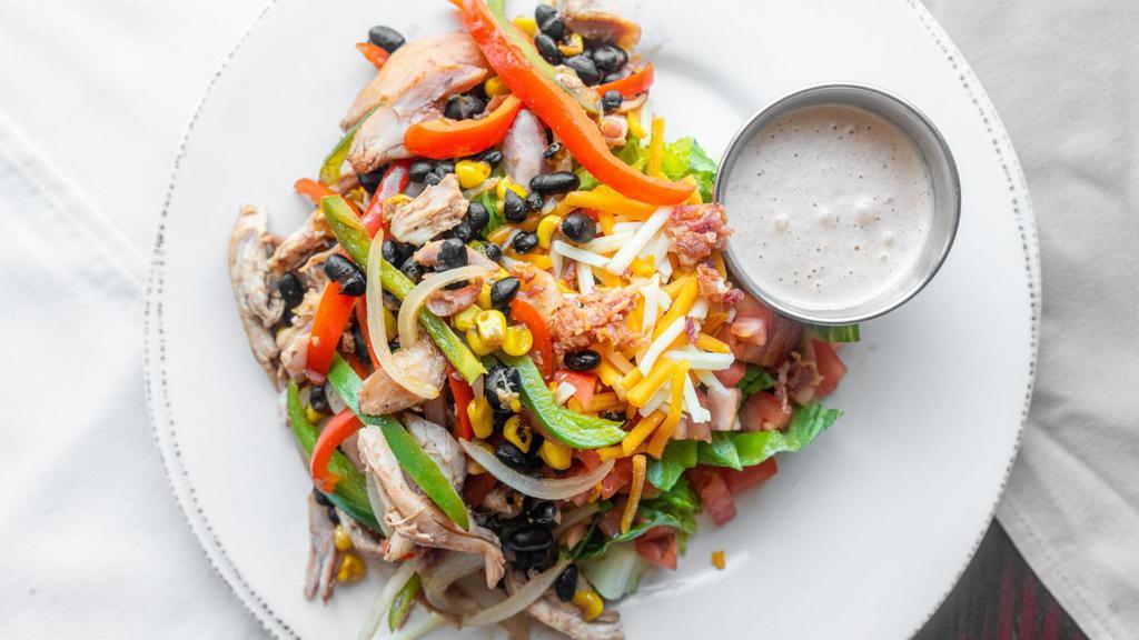 Applewood Bacon & Fajita Chicken Salad · Fajita seasoned smoked chicken, fresh peppers, onions & roasted corn on top of local romaine with smoked bacon, cheddar jack cheeses, tomatoes, black beans, and chipotle ranch dressing.