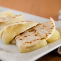 Quesadilla · Two flour tortillas filled with chihuahua cheese and served with sour cream & guacamole.