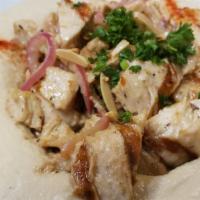 Hommous With Chicken · Hommous topped with sautéed chicken and pine nuts.