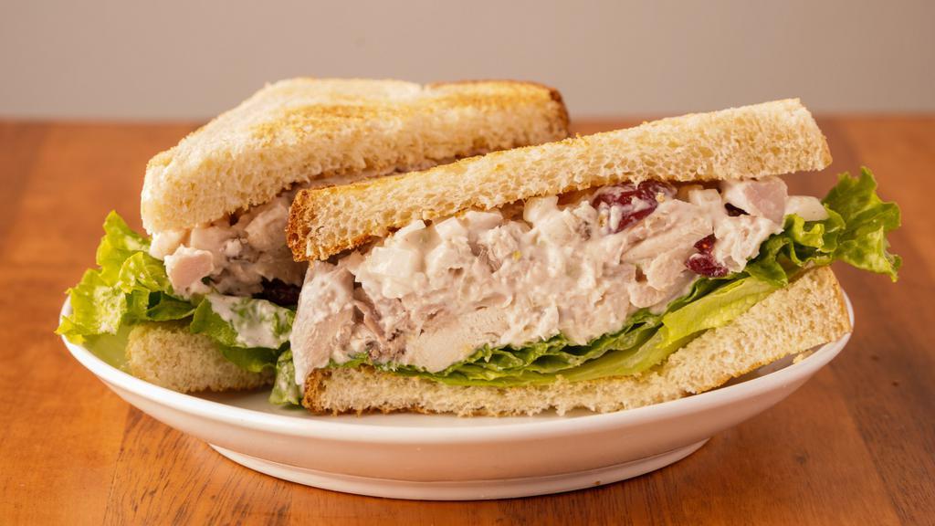 Freshmade Chicken Salad · Our chicken salad is made from hand chopped chicken, diced onion, diced celery, sliced grapes, pecans, dried cranberries, and tossed in a creamy mayonnaise-based dressing! It can be served on sourdough bread with crisp lettuce or made into a wrap with crisp lettuce inside!