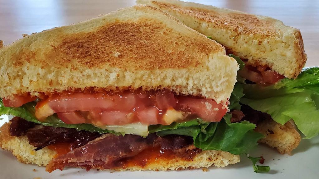 Big Blt · Our blt is made with five slices of bacon, crisp lettuce, juicy tomato slices, and topped with french dressing! Served on toasted thick cut texas toast!