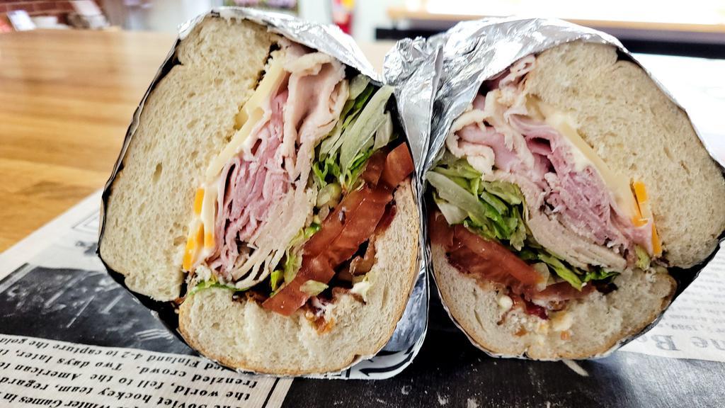 Club Sub · Our Club Sub has sliced turkey and ham! Topped with Swiss & Colby Jack cheese, sliced tomato, shredded lettuce, mayonnaise, crispy bacon! All on top of a sub bun!