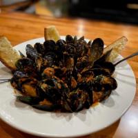 Mussels Pomodoro · sautéed in a spicy tomato sauce, garlic, evoo, fresh herbs and crostini