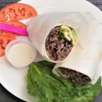 Beef Shawarma Pita · Beef shawarma with lettuce, tomatoes, cucumber, onions, and your choice of sauce wrapped in ...