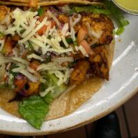 Chicken Tacos(2) · Grilled Adobo Marinated chicken breast, with lettuce and shredded pepper jack cheese, served...
