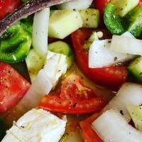 Greek Salad · Lettuce, tomatoes, onions, peppers, cured olives, Feta cheese and cured anchovies.