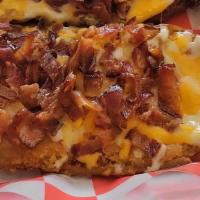 Potato Skins · Deep Fried Potato Skins topped w/ melted cheese, freshly chopped bacon & grilled onions & si...
