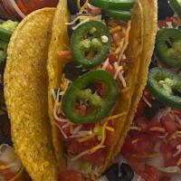 Beef Tacos  · 3 beef tacos topped w/ shredded cheddar, lettuce, tomatoes, onion, black olives, & jalapeños...